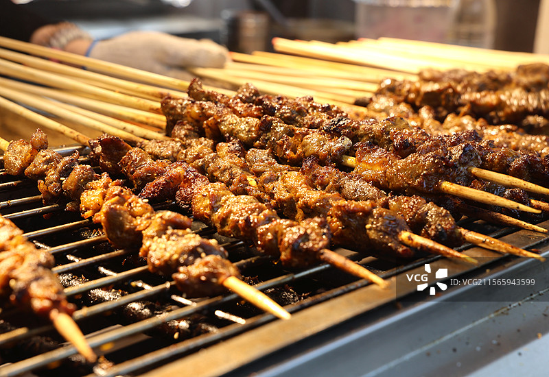 烧烤架上烤羊肉串牛肉串猪肉串的特写镜头图片素材