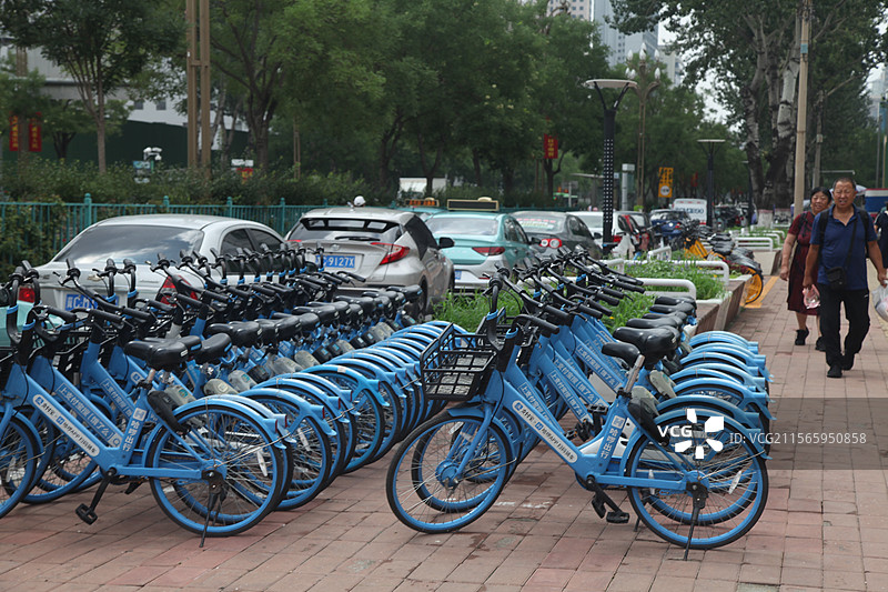 2023年12月31日，重庆江北区共享单车共享自行车整齐停放路边共享单车共享自行车城市出行工具黄车图片素材