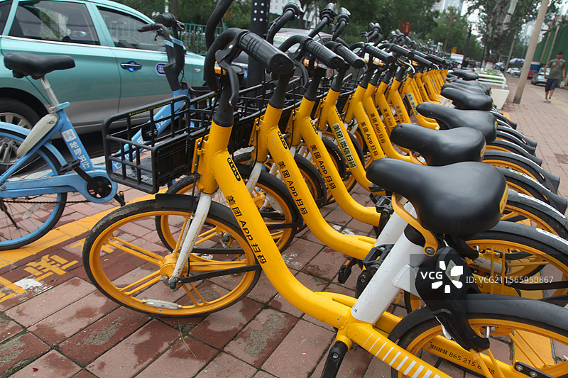 2023年12月31日，重庆江北区共享单车共享自行车整齐停放路边共享单车共享自行车城市出行工具黄车图片素材