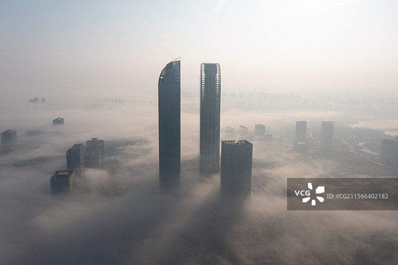 航拍晨雾中的宁夏银川城市天际线摩天大楼图片素材