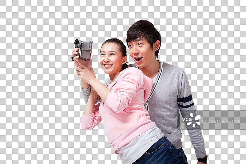 快乐的年轻情侣使用数码摄像机图片素材