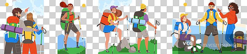 人们在山中徒步旅行，手持登山杖。图片素材