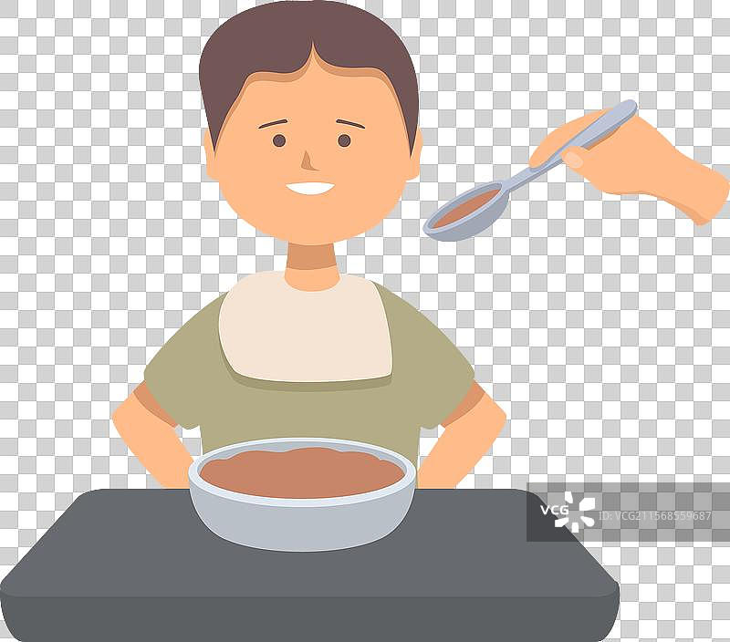 快乐的小男孩在桌子上吃碗里的粥图片素材