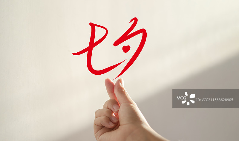 手指比心，墙上是七夕的手写字图片素材