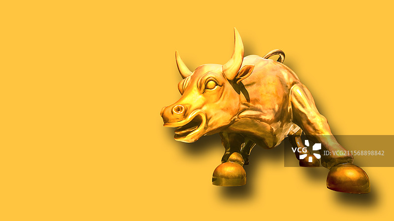 金色背景下的一头金牛小雕像图片素材