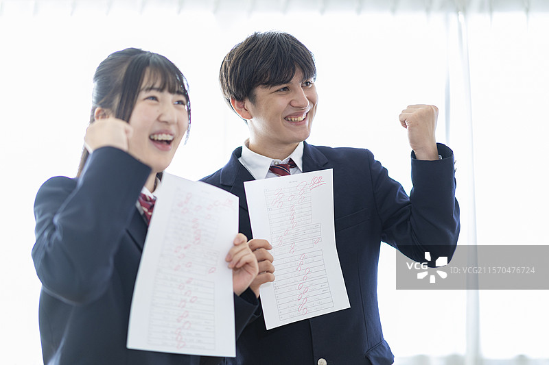 高中男生女生手持满分试卷图片素材