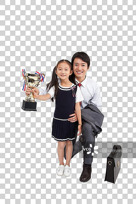 棚拍商务装年轻父亲穿裙子的小女孩拿奖杯图片素材