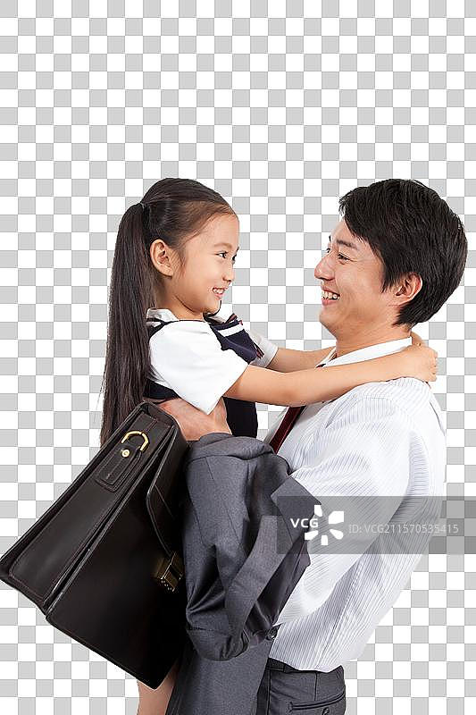 棚拍商务装年轻父亲抱着穿裙子的小女孩图片素材