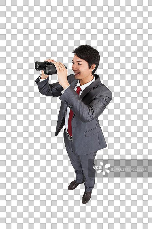 棚拍商务装年轻男人拿望远镜眺望图片素材