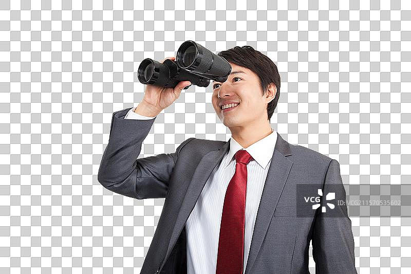 棚拍商务装年轻男人拿望远镜眺望图片素材