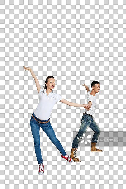 棚拍穿休闲装的年轻情侣跳舞图片素材