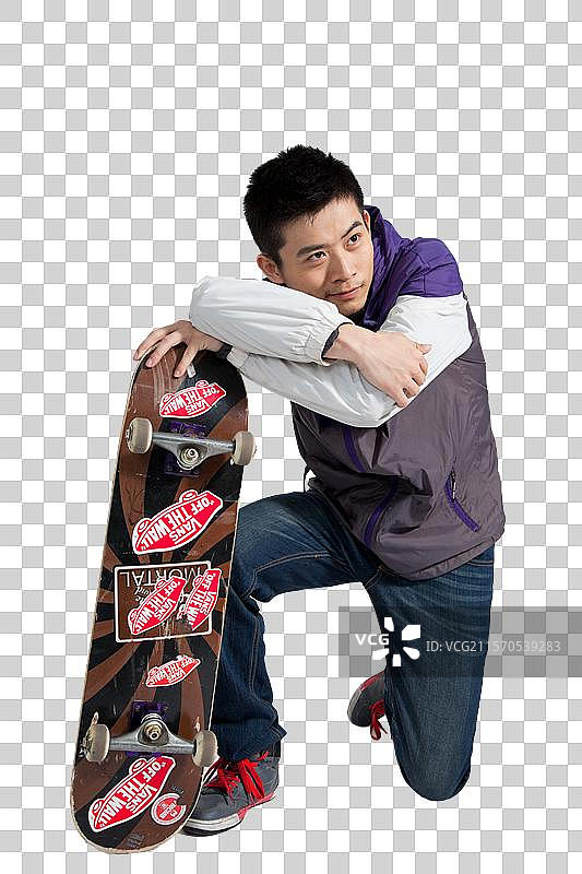 棚拍年轻男人拿着滑板图片素材