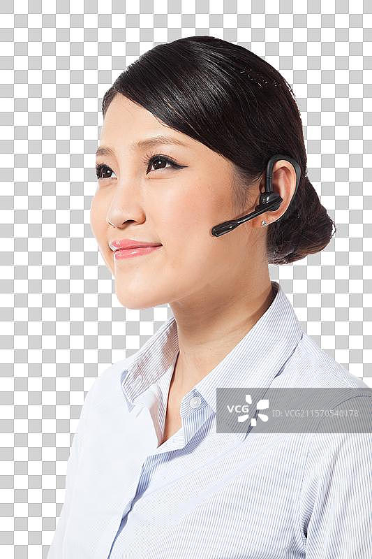 棚拍戴蓝牙耳机的年轻商务女士图片素材