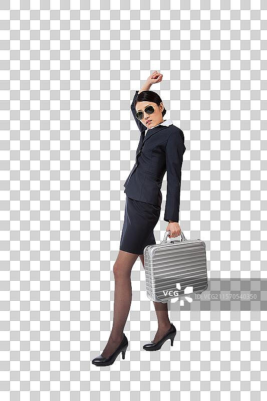 棚拍年轻商务女士和手提箱图片素材