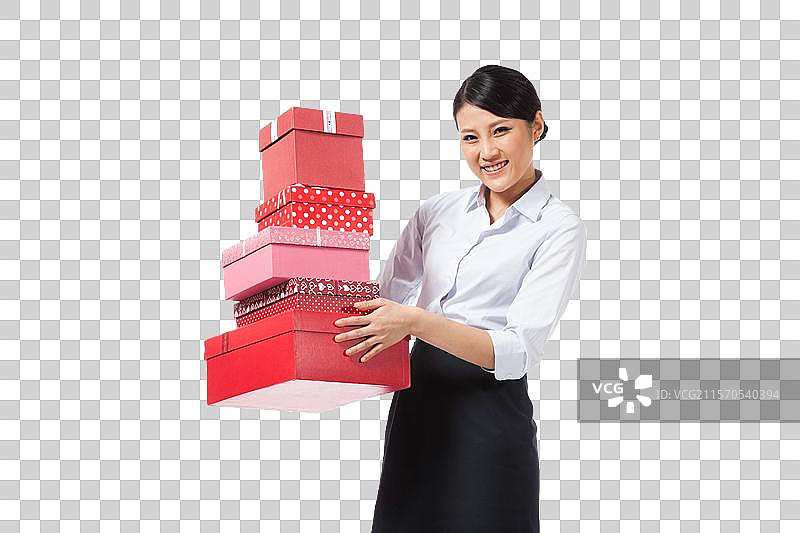 棚拍年轻商务女士抱着礼物盒图片素材