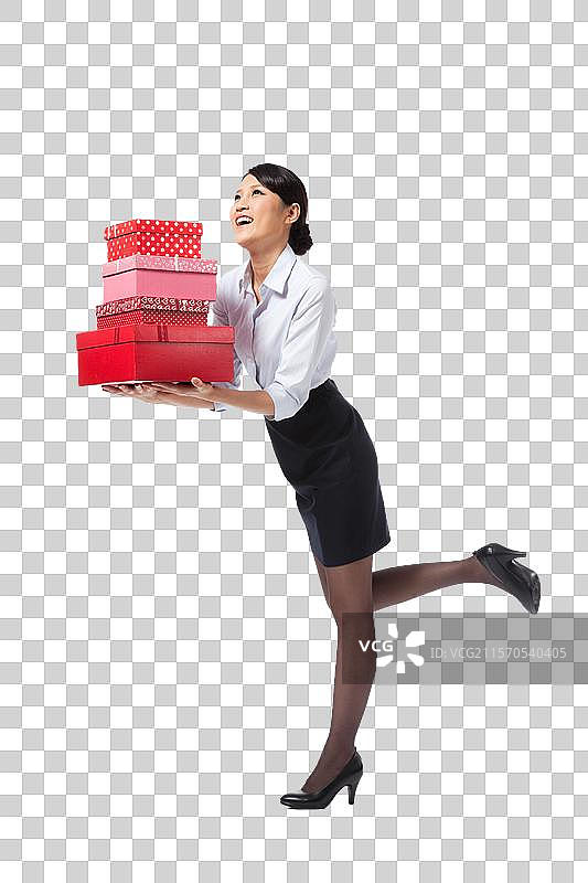 棚拍年轻商务女士抱着礼物盒图片素材