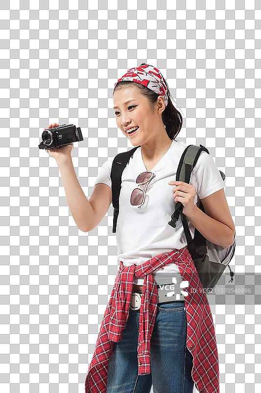 棚拍年轻女人户外旅行拿着DV拍摄图片素材