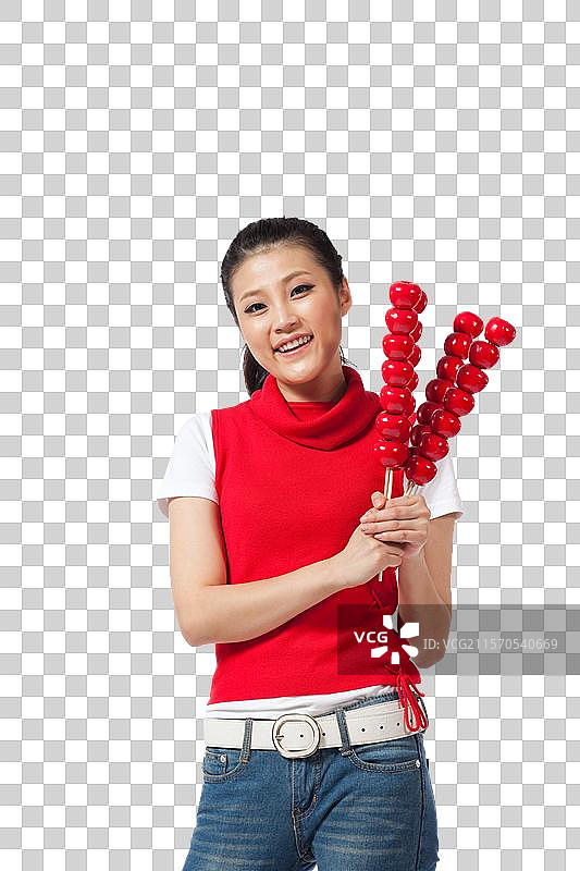 棚拍年轻女人拿着糖葫芦图片素材