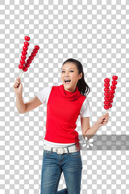 棚拍年轻女人拿着糖葫芦图片素材