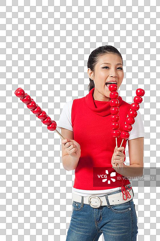 棚拍年轻女人拿着糖葫芦图片素材