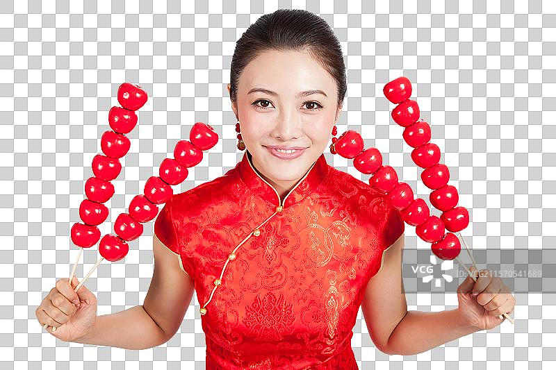 棚拍身穿中国传统服装的年轻女人和糖葫芦图片素材