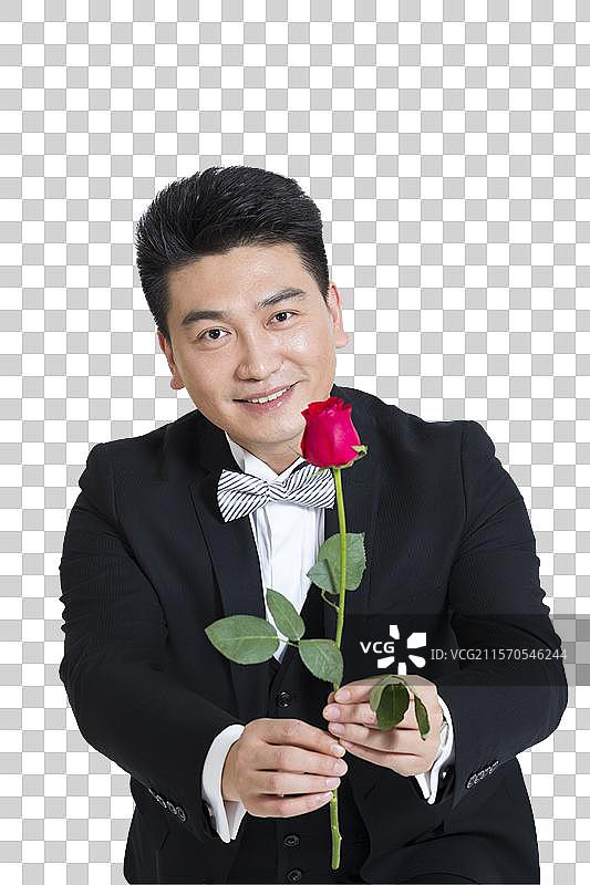 棚拍中年商务男士拿着一支玫瑰花图片素材