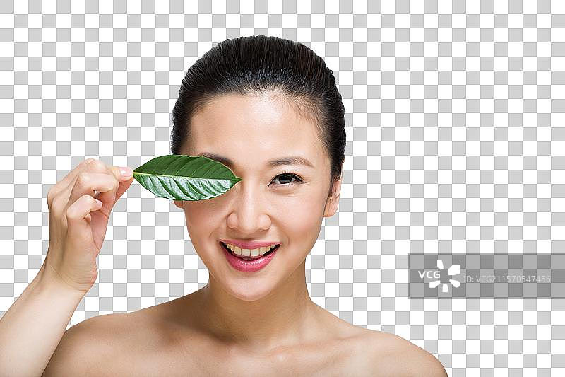 棚拍年轻女人和绿叶图片素材