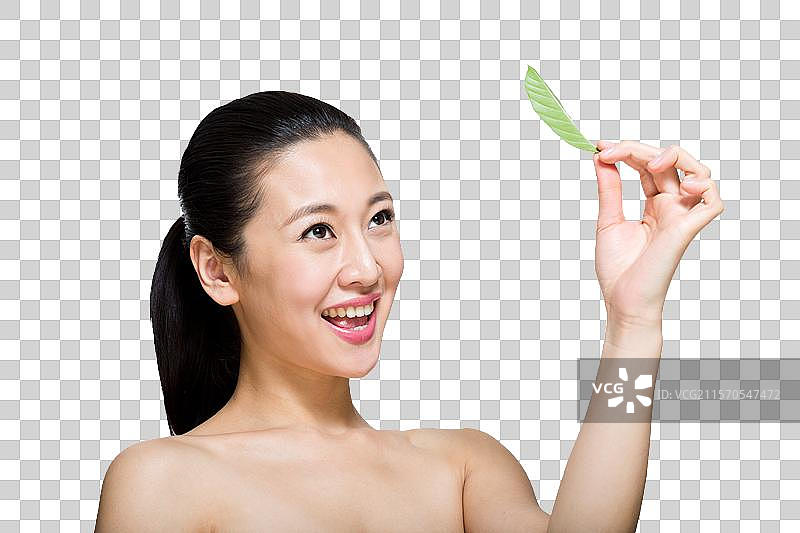 棚拍年轻女人和绿叶图片素材