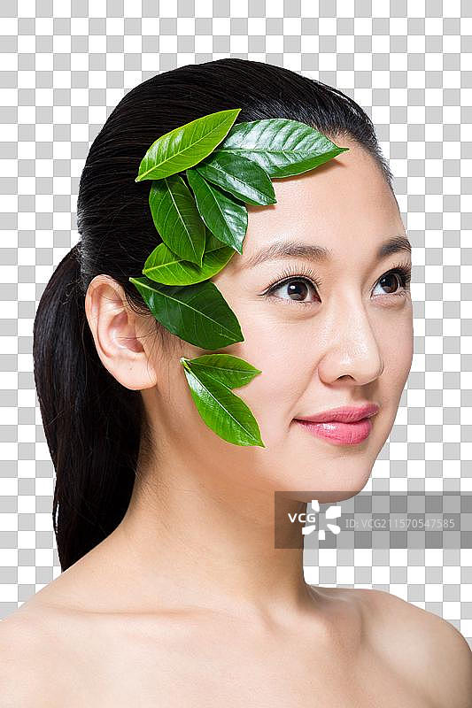 棚拍年轻女人和绿叶图片素材