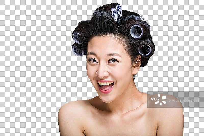 棚拍戴卷发棒的年轻女人图片素材