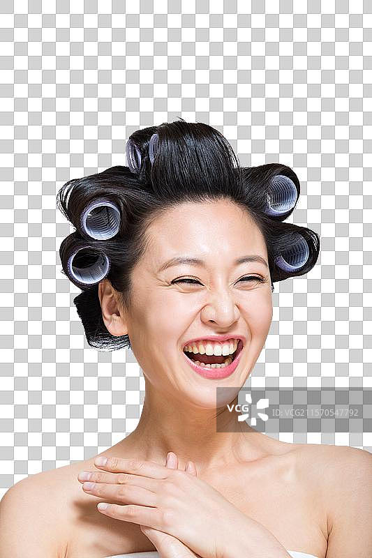 棚拍戴卷发棒的年轻女人图片素材