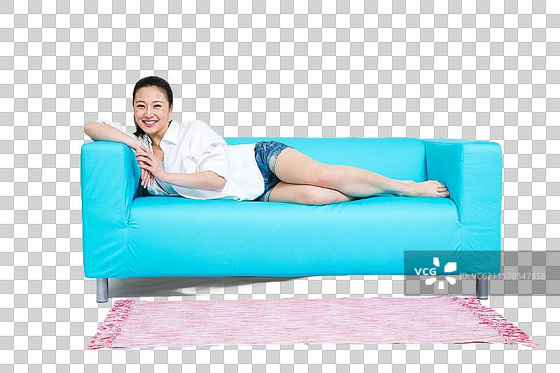 棚拍年轻女人躺在沙发上休息图片素材