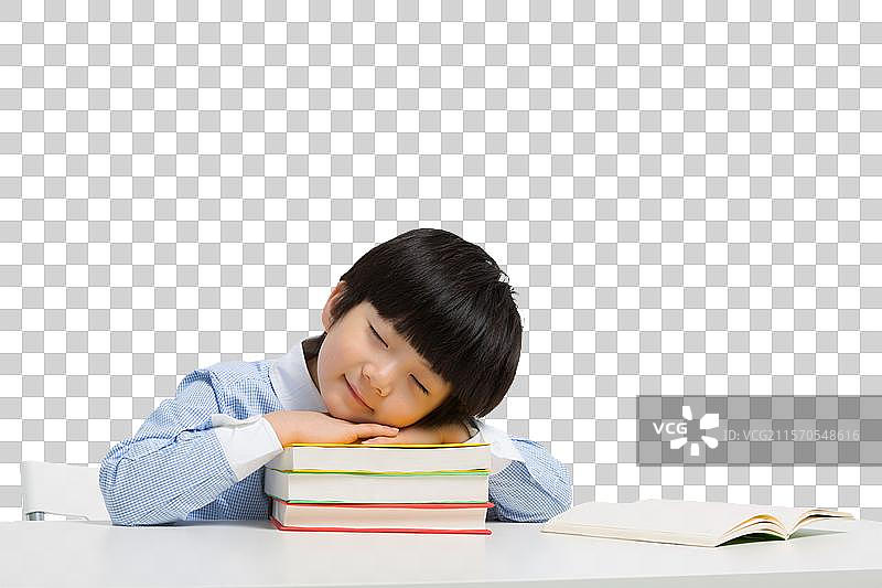 小男孩趴在书本上睡觉图片素材