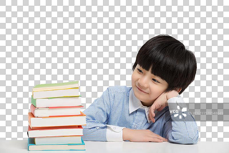 小男孩在书桌前思考图片素材