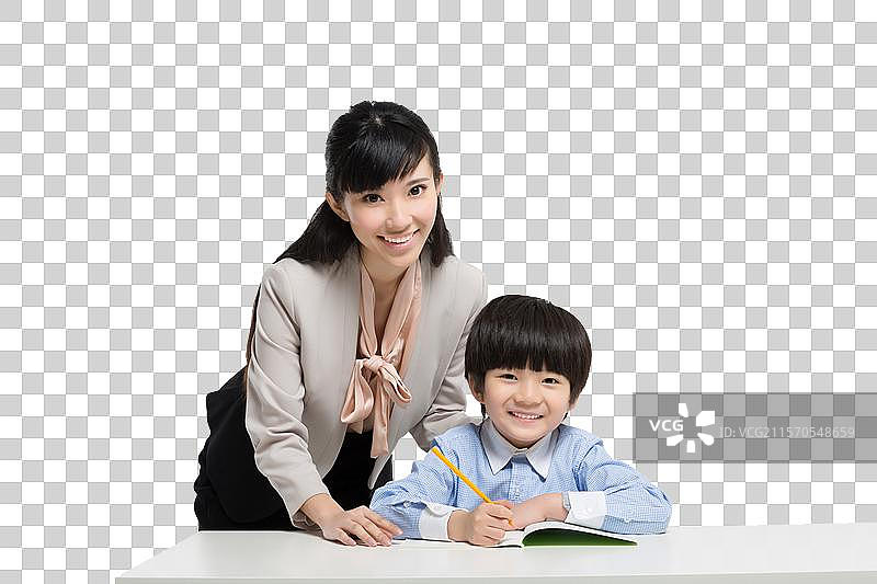 女教师辅导小男生学习图片素材