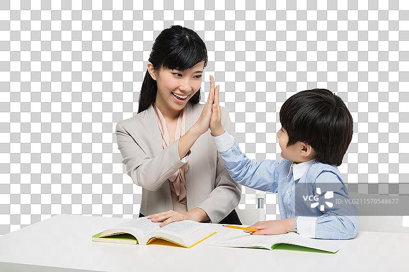 女教师辅导小男生学习图片素材