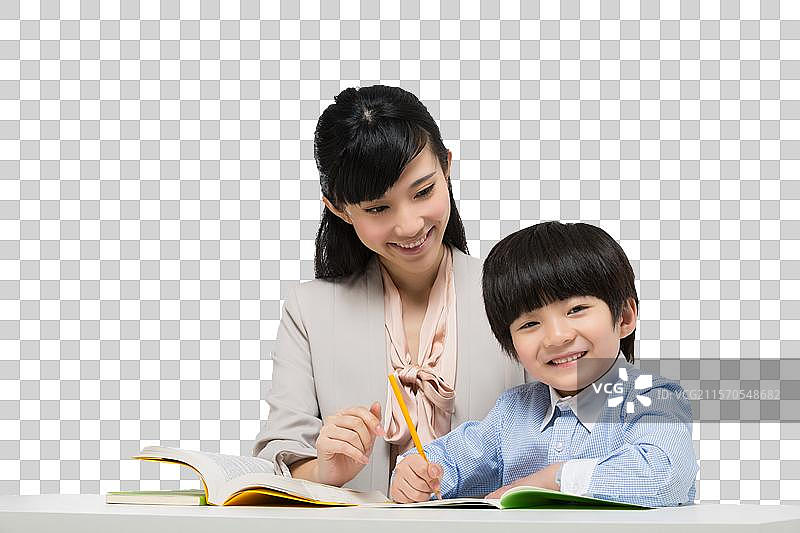 女教师辅导小男生学习图片素材