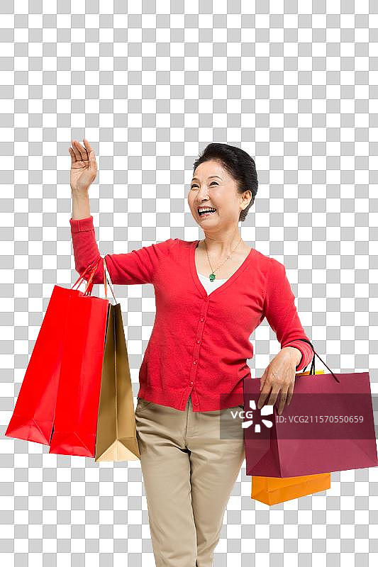 棚拍中老年女性提着购物袋图片素材
