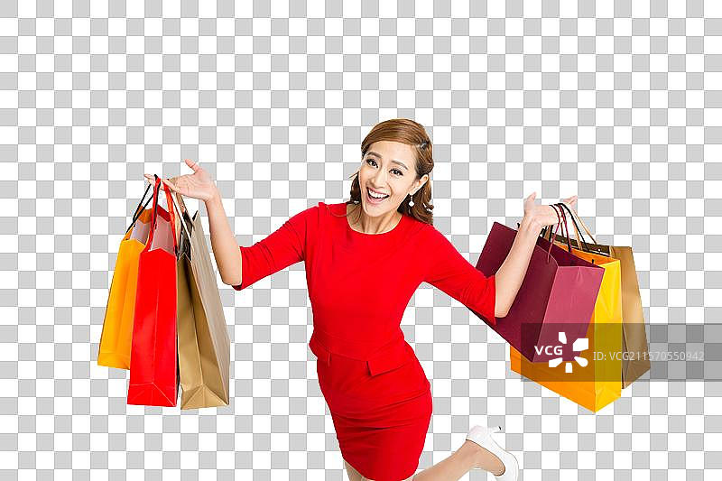 棚拍红裙子的年轻女人提着购物袋图片素材