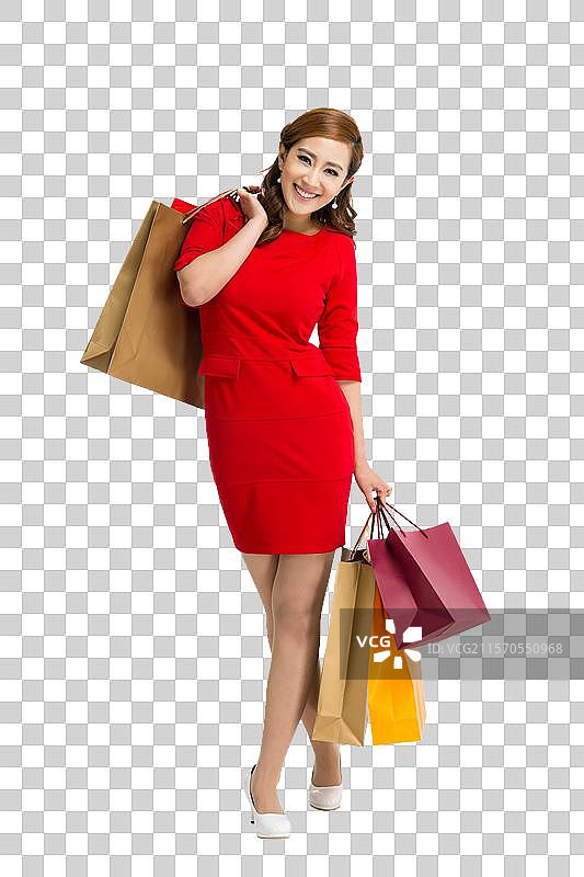 棚拍红裙子的年轻女人提着购物袋图片素材