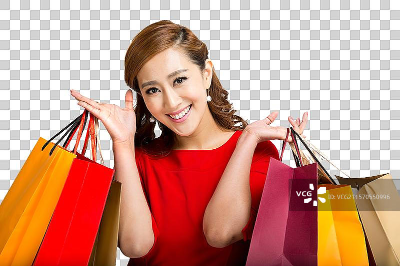 棚拍红裙子的年轻女人提着购物袋图片素材