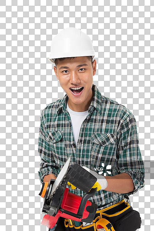年轻的建筑工人拿电锯图片素材