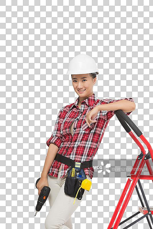 年轻的女建筑工人拿着电钻图片素材