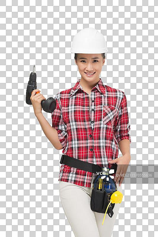 年轻的女建筑工人拿着电钻图片素材
