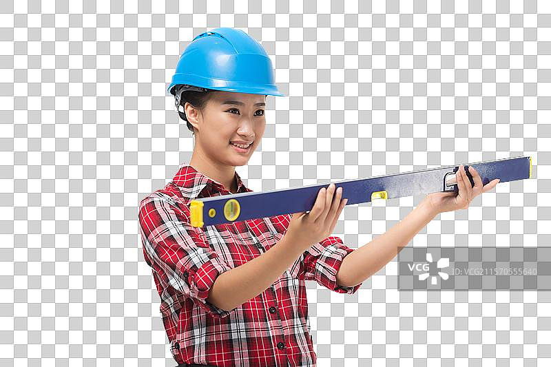年轻的女建筑工人拿着水平仪图片素材