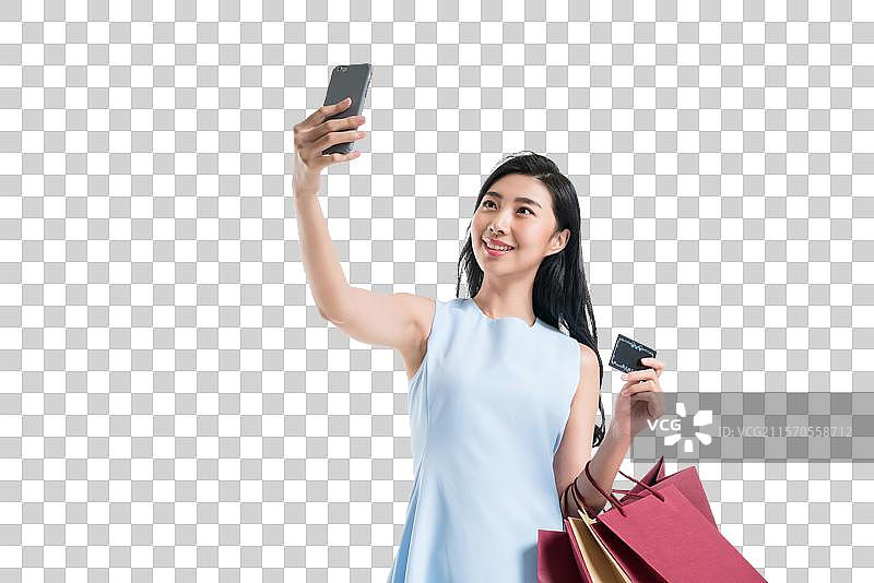 漂亮的年轻女人购物打电话图片素材