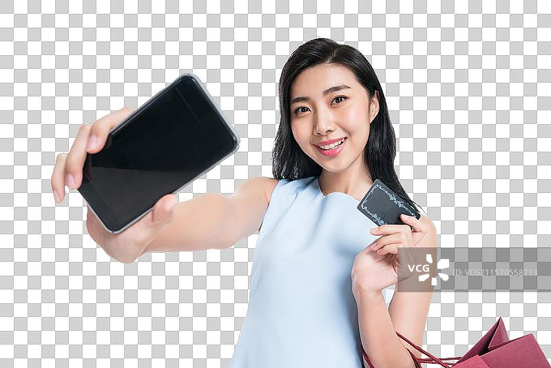 漂亮的年轻女人购物打电话图片素材