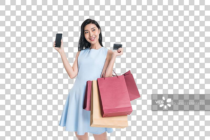 漂亮的年轻女人购物打电话图片素材