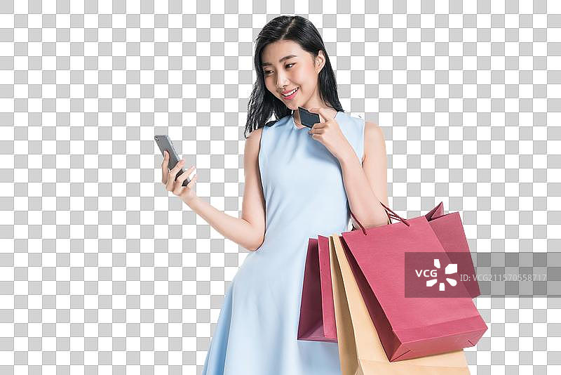 漂亮的年轻女人购物打电话图片素材