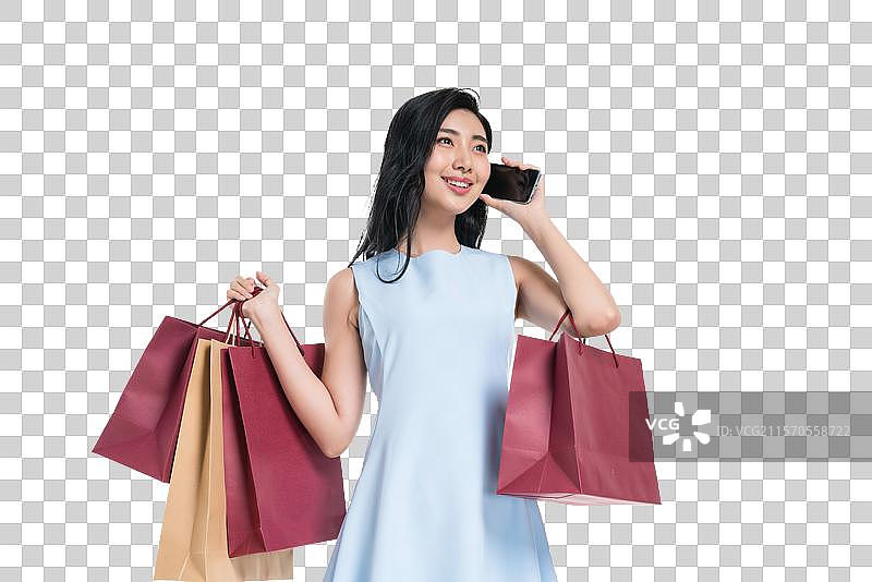 漂亮的年轻女人购物打电话图片素材